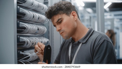 IT Engineer Assembles Custom Ethernet Patch Cord by Crimping RJ45 Connector Onto Twisted Pair Cable, Verifying Pinout and Maintaining Organized Structured Cabling For Reliable Network Connectivity.