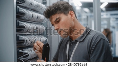 IT Engineer Assembles Custom Ethernet Patch Cord by Crimping RJ45 Connector Onto Twisted Pair Cable, Verifying Pinout and Maintaining Organized Structured Cabling For Reliable Network Connectivity.