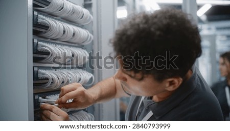 IT Engineer Assembles Custom Ethernet Patch Cord by Crimping RJ45 Connector Onto Twisted Pair Cable, Verifying Pinout and Maintaining Organized Structured Cabling For Reliable Network Connectivity.