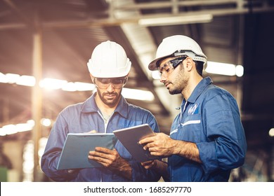 Engineer Audit Worker Working Team Together With Safety Uniform And White Helmet To Work In Industry Factory Handle Tablet And Checklist.