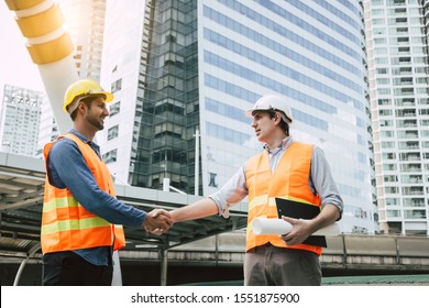 Engineer Boss Get Handshake, Saying Thank You To Blue Collar Worker Or Team For Doing Work Successfully. Employee Happy. Blue Collar Workers Men Wear Hard Hat For Safety. Engineer Man Hold Blue Print