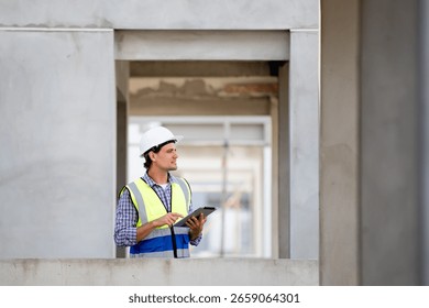 Engineer builder. Foreman work in construction site. Construction site manager standing wearing safety vest and helmet,using his tablet at construction site. - Powered by Shutterstock - Get 15% off with code: PIKWIZARD15