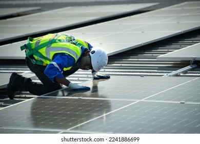 Engineer in charge of solar panel installation The installation of solar energy conversion into electricity for a warehouse is currently being investigated.