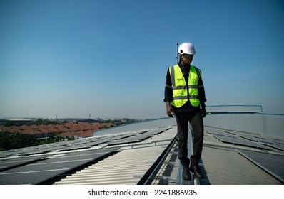 Engineer in charge of solar panel installation The installation of solar energy conversion into electricity for a warehouse is currently being investigated.