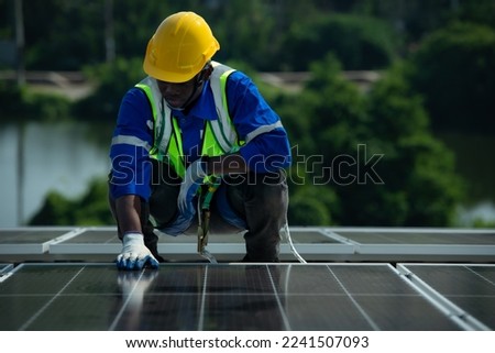 Engineer in charge of solar panel installation The installation of solar energy conversion into electricity for a warehouse is currently being investigated.