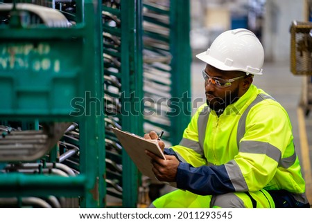 Engineer check and control automation robot arms.Robot arms machine in intelligent factory industrial on monitoring system software. Welding robotics and digital manufacturing operation.