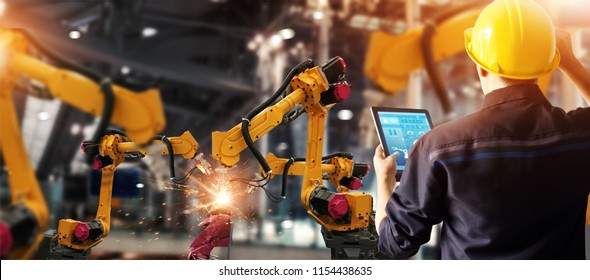 Engineer check and control welding robotics automatic arms machine in intelligent factory automotive industrial with monitoring system software. Digital manufacturing operation. Industry 4.0 - Shutterstock ID 1154438635