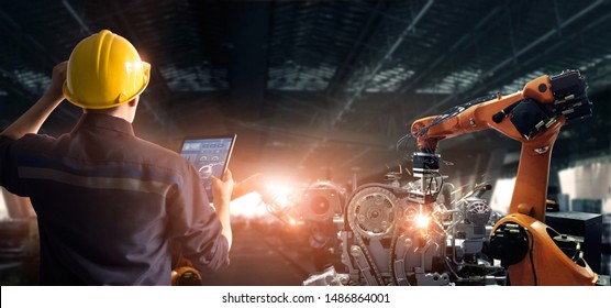 Engineer check and control welding robotics automatic arms machine in intelligent factory automotive industrial with monitoring system software. Digital manufacturing operation. Industry 4.0 - Shutterstock ID 1486864001