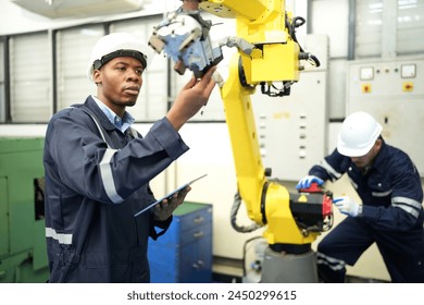 Engineer check and control welding robotics automatic arms machine in intelligent factory automotive industrial with monitoring system software. Digital manufacturing operation.  - Powered by Shutterstock