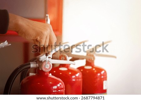 Engineer check fire suppression system,check fire extinguisher tank in the fire control room for safety