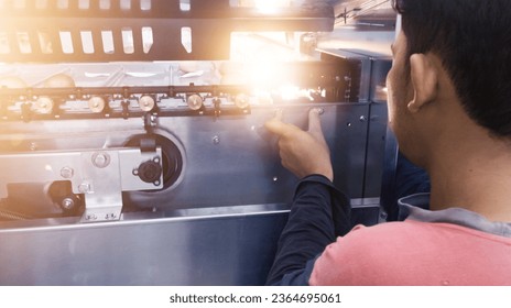 The Engineer checking and re adjusting the automatic eggs sorting machine on hatchery industry. - Shutterstock ID 2364695061