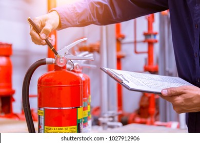 Engineer checking Industrial fire control system,Fire Alarm controller, Fire notifier, Anti fire.System ready In the event of a fire. - Shutterstock ID 1027912906