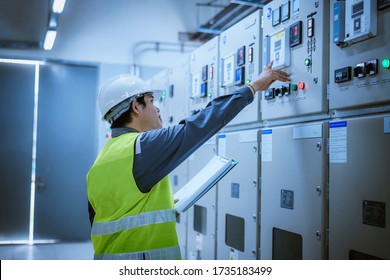 The engineer checking and inspecting at MDB panel.he working with electric switchboard to check range of voltage working in Main Distribution Boards factory.