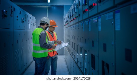 Engineer checking and inspecting at MDB panel .they working with electric switchboard to check range of voltage working in Main Distribution Boards factory. - Shutterstock ID 2014173029