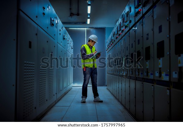 The engineer checking and\
inspecting at MDB panel .he working with electric switchboard to\
check range of voltage working in Main Distribution Boards\
factory.