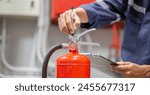 Engineer are checking and inspection a fire extinguishers tank in the fire control room for safety training and fire prevention.