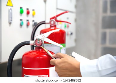 Engineer Are Checking And Inspection A Fire Extinguishers In The Fire Control Room For Safety And Prevention.