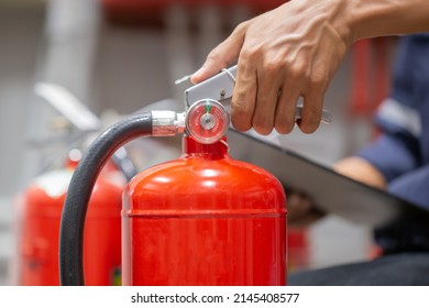 Engineer Are Checking And Inspection A Fire Extinguishers Tank In The Fire Control Room For Safety Training And Fire Prevention.