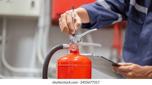 Engineer are checking and inspection a fire extinguishers tank in the fire control room for safety training and fire prevention.