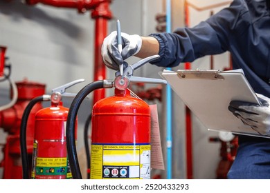 Engineer are checking and inspection a fire extinguishers tank in the fire control room for safety training and fire prevention.