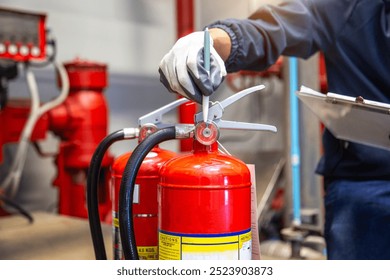 Engineer are checking and inspection a fire extinguishers tank in the fire control room for safety training and fire prevention.