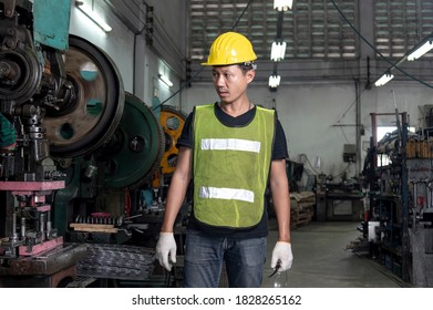 Engineer checking and inspects quality of industrail machine in factory with confident 