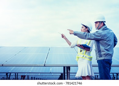engineer checking job routine of labor working on cleaning solar panel at outside ; operation working on preventive and maintenance in solar power plant for great efficiency