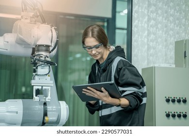 Engineer checking and operation robot arm at factory,Technology, automation,Innovation and engineering concept.