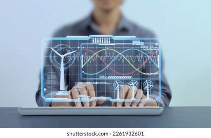 Engineer is checking the power parameters real time status of a wind turbine generator through AI Hologram screen. Artificial intelligence, helps in analyzing and solving energy problems. Green energy