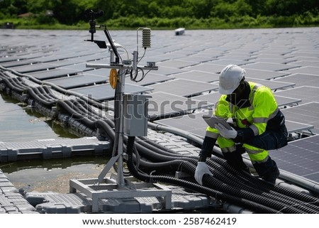 Engineer checking solar panels on a floating buoy. The power plant uses water and renewable energy to produce eco-friendly electricity.