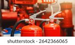 Engineer checks fire extinguisher in fire control room to ensure safety. When an emergency occurs