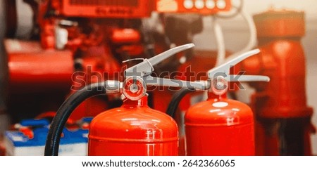 Engineer checks fire extinguisher in fire control room to ensure safety. When an emergency occurs