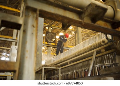 Engineer Cleaning Machine In Factory.