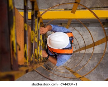 Engineer climb up to the top of overhead crane to inspect and check condition as preventive maintenance plan. - Powered by Shutterstock