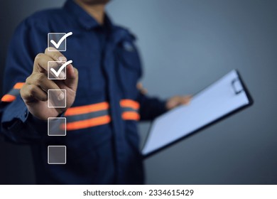 Engineer with clipboard using pen to tick correct sign or check mark on checkbox to complete task and things to do checklist in document control syetem. Project approve and audit done concept. - Shutterstock ID 2334615429
