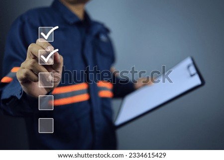 Engineer with clipboard using pen to tick correct sign or check mark on checkbox to complete task and things to do checklist in document control syetem. Project approve and audit done concept.