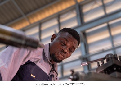 Engineer closely inspecting precision components on a metal lathe machine. Focus, technical expertise, industrial engineering, mechanical work, and manufacturing process. - Powered by Shutterstock - Get 15% off with code: PIKWIZARD15