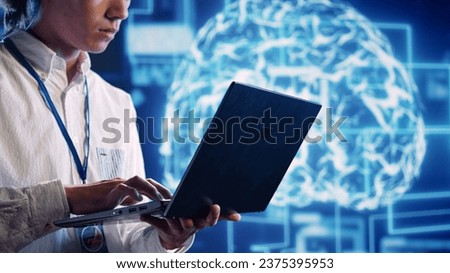 Engineer in cloud computing business uses artificial intelligence computing simulating human brain thought processes. Admin performing operations on laptop with AI machine learning algorithms