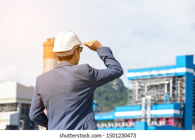 Engineer With A Coal Power Plant In The Background, Thailand