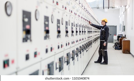 Engineer commissioning bay control unit. Engineering department. Medium voltage switchgear