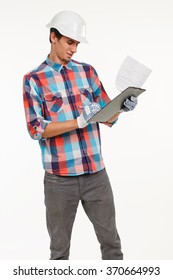 Engineer Compares Quantity Surveying. Builder Checking Construction Material. Handsome Young Engineer With Clipboard.