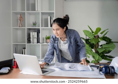 Engineer Conducting Thorough Research for Project Development on Laptop