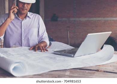engineer and construction team working on checking progress of construction site
