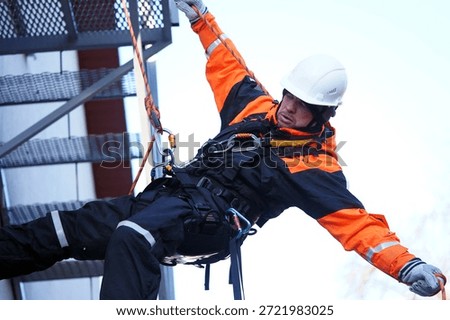 Engineer, construction worker. Man in uniform. Rock climber, arborist. Industrial climber. Working at height. Rescuer, firefighter, dangerous occupation, ropes, carabiners.                               