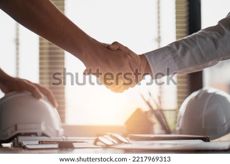 Engineer constructor handshake meeting with architect owner for agreement in contract building home project