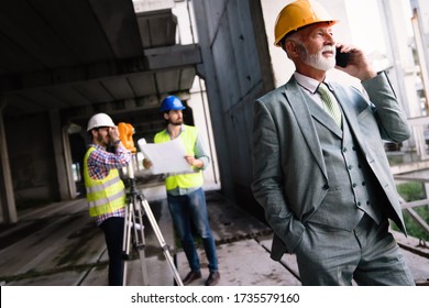 Engineer, contractor, architect teamwork. Construction people talking and planning work, blueprint