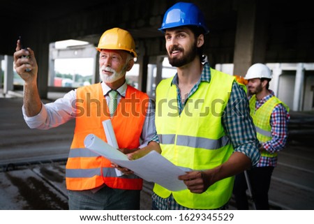 Engineer, contractor, architect teamwork. Construction people talking and planning work, blueprint