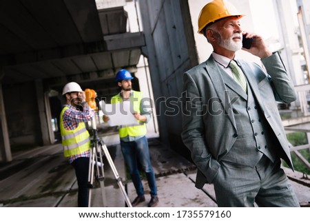 Engineer, contractor, architect teamwork. Construction people talking and planning work, blueprint