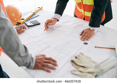 Engineer And Contractor Discussing Draft On The Table