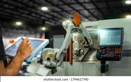 Engineer Control And Check Robotics Automatic Arms Machine Welding In Intelligent  Smart Factory Automotive Industrial With Tablet Monitoring System Software. Digital Manufacturing Operation,Industry 